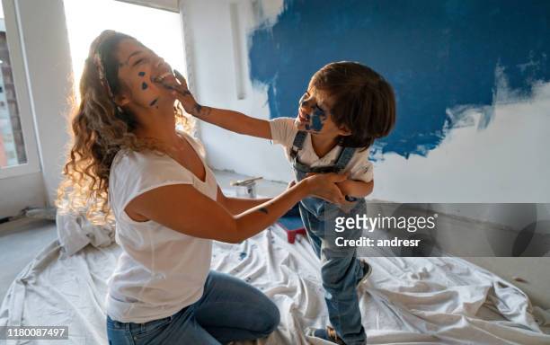 mother and son painting their house and having fun - face painting imagens e fotografias de stock