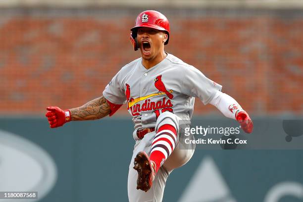Kolten Wong of the St. Louis Cardinals celebrates after hitting a two-RBI double against the Atlanta Braves during the first inning in game five of...