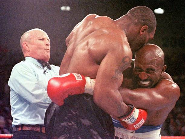 Referee Lane Mills steps in as Evander Holyfield reacts after Mike Tyson bit his ear in the third round of their WBA heavyweight championship fight...