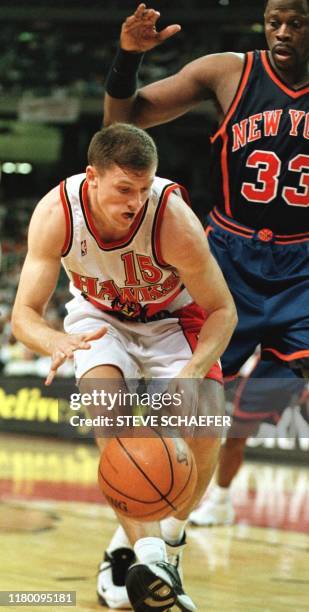 Atlanta Hawks Jeff Shepperd reaches for a loose ball while being guarded by New York Knicks Patrick Ewing during their game 09 April, 1999 in...