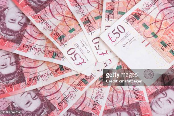 spread of random 50 british pound notes - 50 pound notes stock pictures, royalty-free photos & images
