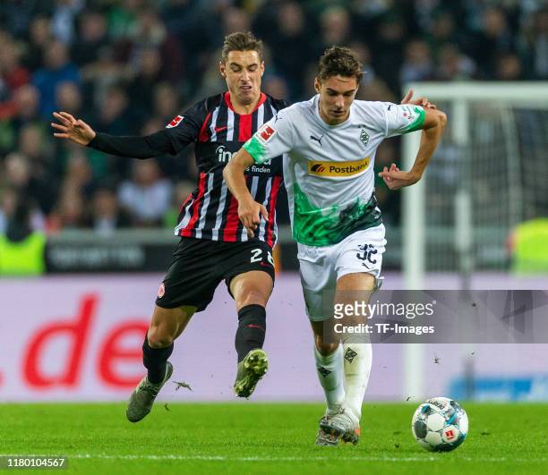 Dominik Kohr of Eintracht Frankfurt and Florian Neuhaus of Borussia Moenchengladbach battle for the ball during the Bundesliga match between Borussia...