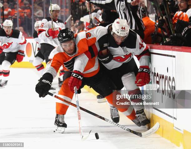 Ivan Provorov of the Philadelphia Flyers and Miles Wood of the New Jersey Devils battle for position during the first period at the Wells Fargo...