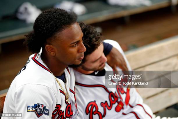 Ozzie Albies and Dansby Swanson of the Atlanta Braves react after their teams 13-1 loss to the St. Louis Cardinals in game five of the National...