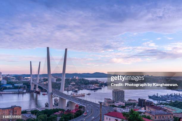 golden bridge in sunset, vladivostok, russia - vladivostok stock pictures, royalty-free photos & images