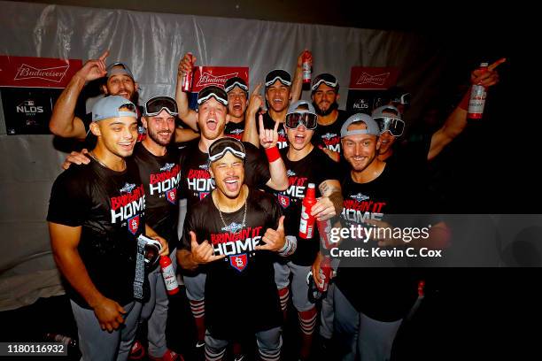 The St. Louis Cardinals celebrate in the locker room after their 13-1 win over the Atlanta Braves in game five of the National League Division Series...