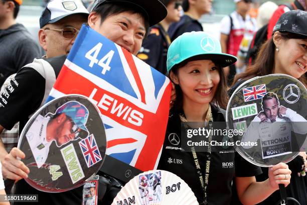 Lewis Hamilton of Great Britain and Mercedes GP fan shows their support during previews ahead of the F1 Grand Prix of Japan at Suzuka Circuit on...