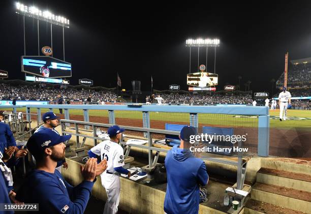 Walker Buehler of the Los Angeles Dodgers walks back to the dug out after being pulled in the seventh inning of game five of the National League...