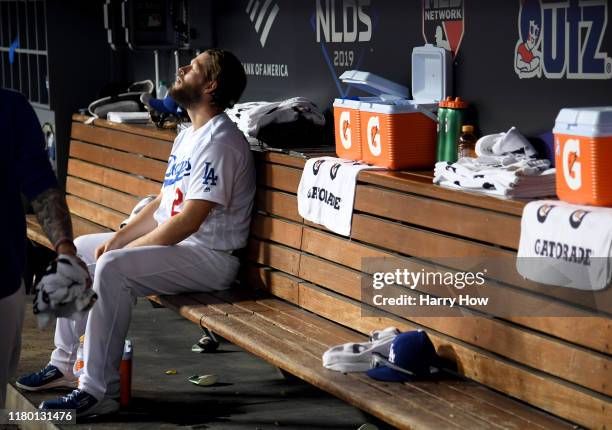 Clayton Kershaw of the Los Angeles Dodgers sits in the dug out after leaving the game after giving up back to back home runs in the eighth inning of...