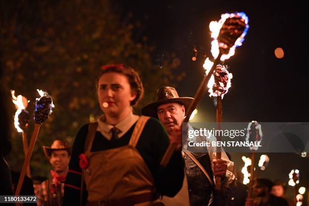 Revellers' torches are carried through the streets of Lewes in East Sussex, southern England, on November 5 during the traditional Bonfire Night...