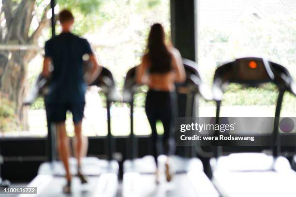 blurred image of fitness people running on treadmill at gym. - fat burning stock pictures, royalty-free photos & images