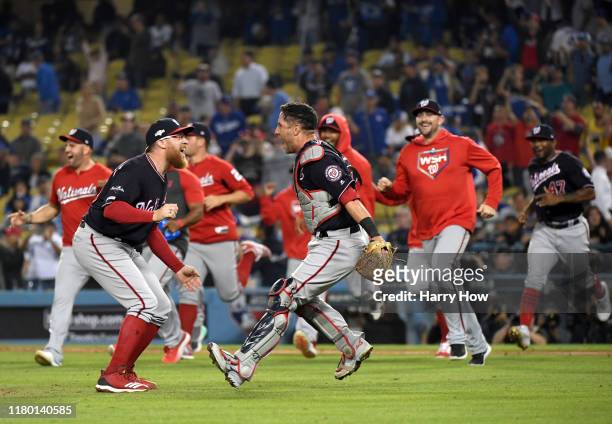 Sean Doolittle and catcher Yan Gomes of the Washington Nationals celebrate the final out of the tenth inning as the Nationals defeated the Los...