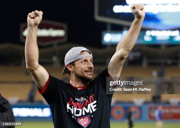 Max Scherzer of the Washington Nationals celebrates defeating the Los Angeles Dodgers 7-3 in ten innings to win game five and the National League...