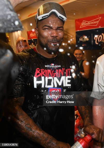 Howie Kendrick of the Washington Nationals celebrates in the locker room after his team defeated the Los Angeles Dodgers 7-3 in ten innings to win...