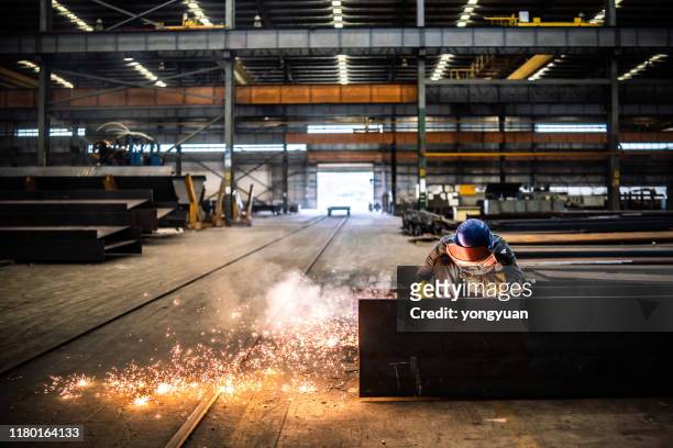 welder working in a factory - industrial workers stock pictures, royalty-free photos & images