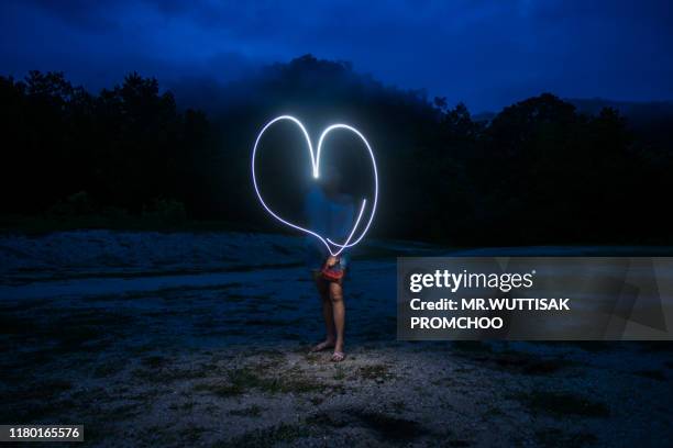 heart shaped fire line. - glowing heart stock pictures, royalty-free photos & images