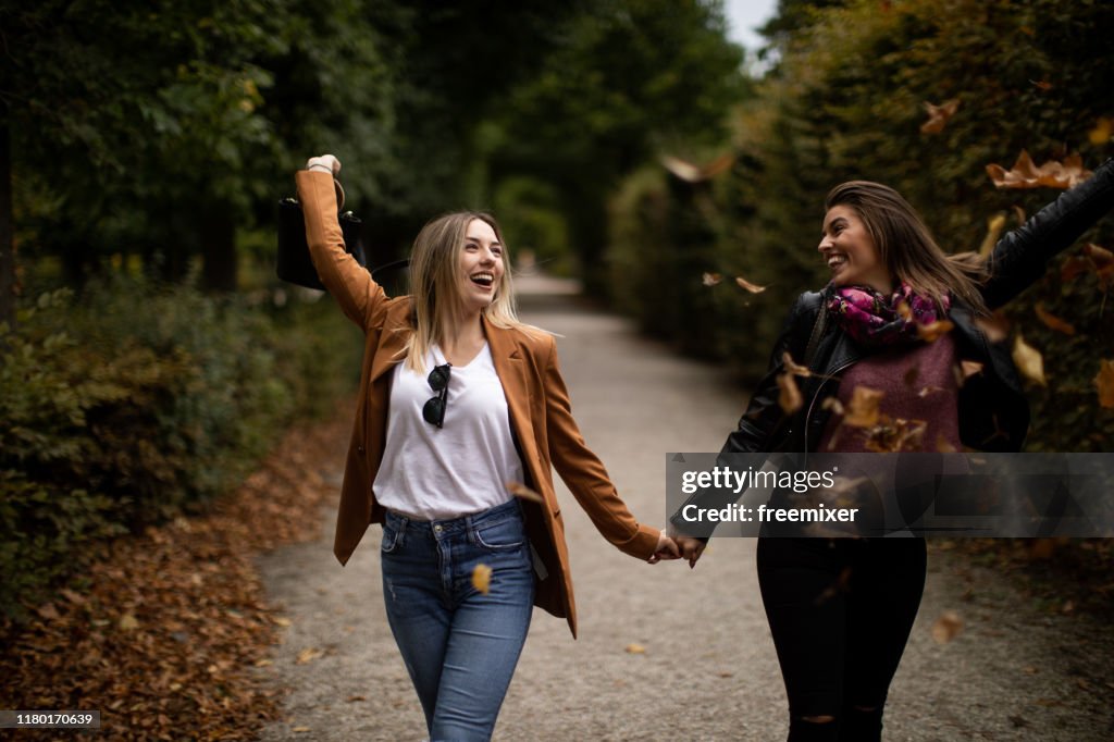 Young lesbian couple walking in park