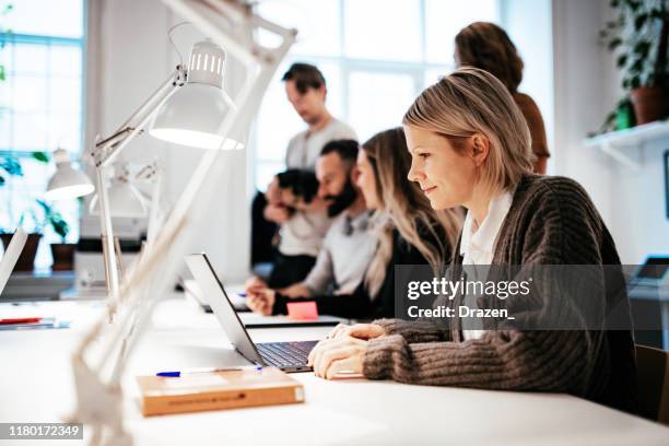 teamwork in modern coworking space - business scandinavia stock pictures, royalty-free photos & images