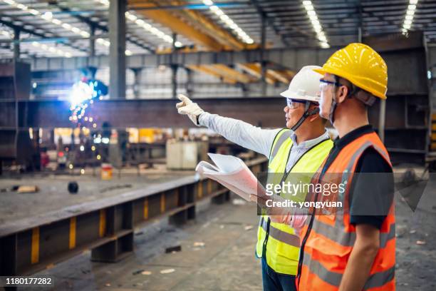 quality inspectors working in a steel factory - safety stock pictures, royalty-free photos & images