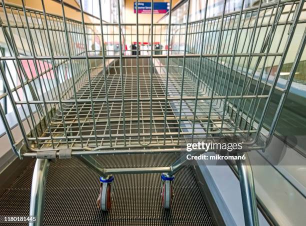 empty shopping cart on shopping trolley escalator - department store stock pictures, royalty-free photos & images