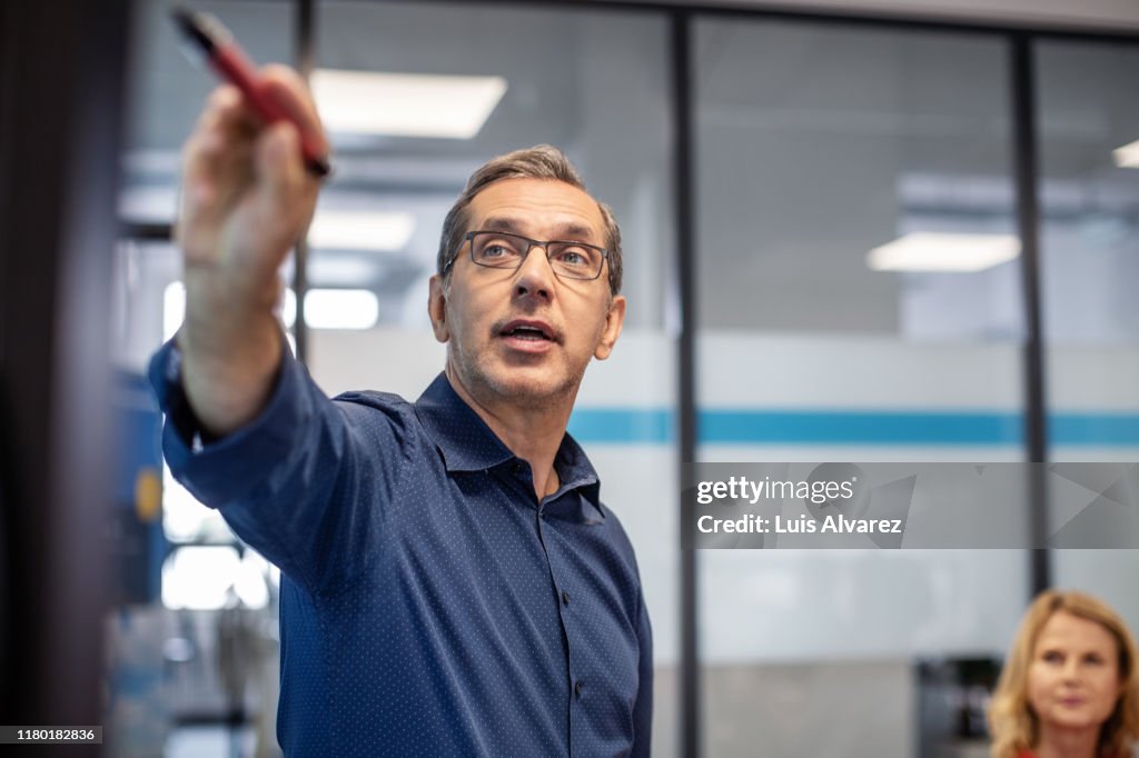 Businessman giving presentation in office