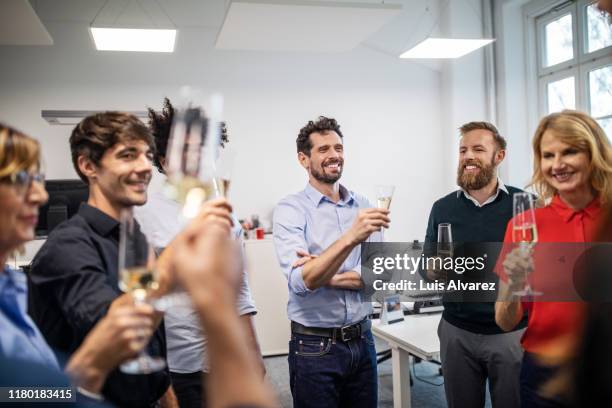 happy business professionals with champagne flutes in office - office party stockfoto's en -beelden