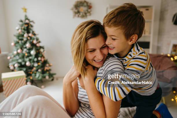tight hug for my mom - christmas morning stock pictures, royalty-free photos & images