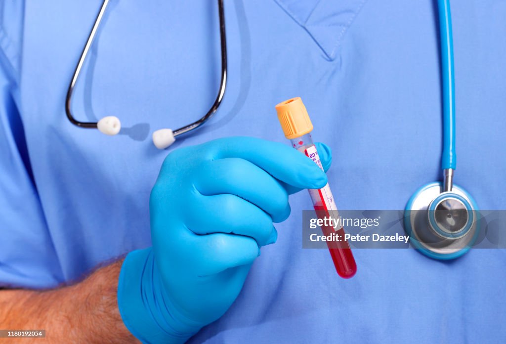 Doctor holding blood in test tube