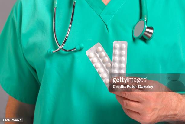doctor offering thyroxine pills - thyroid gland stock-fotos und bilder