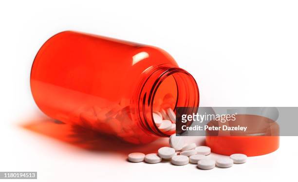 pills spilling out of open pill bottle - 薬物乱用 ストックフォトと画像