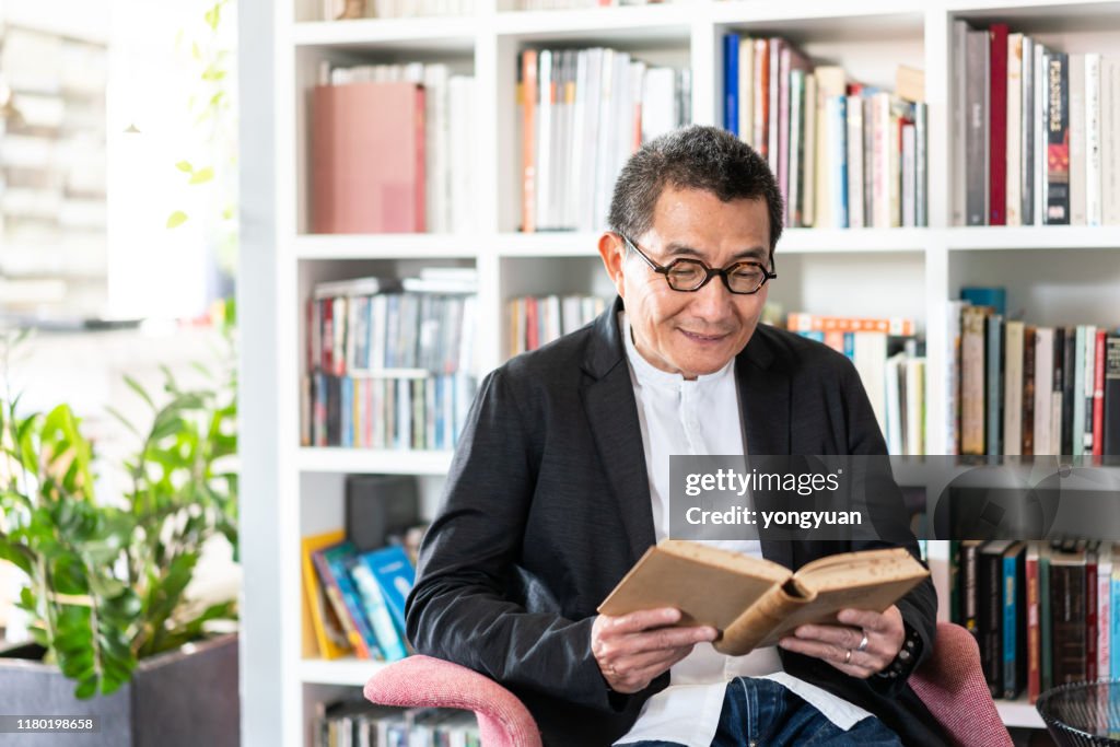 Senior Chinese man reading a book