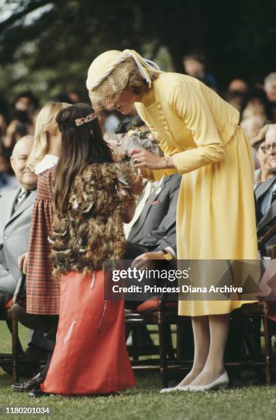 Princess Diana talks to a Maori girl wearing a feather cloak, during a royal visit to the Bay Of Islands, New Zealand, 29th April 1983. The princess...