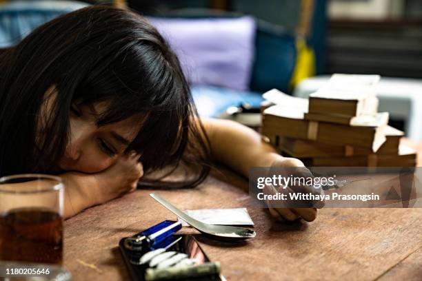 asian women are drug addicts to inject heroin into their veins themselves. - doping pills stock pictures, royalty-free photos & images