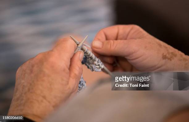 pov of an elderly lady knitting a grandchilds first jumper - lentigo stock pictures, royalty-free photos & images