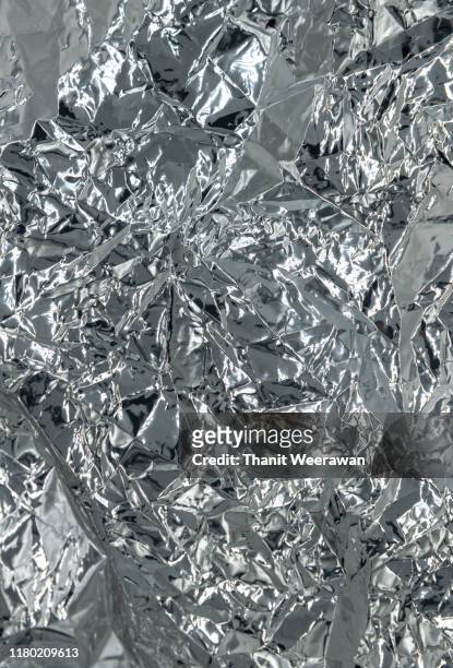 abstract background texture silver color crumpled foil, vertical image. - shiny chrome stock pictures, royalty-free photos & images