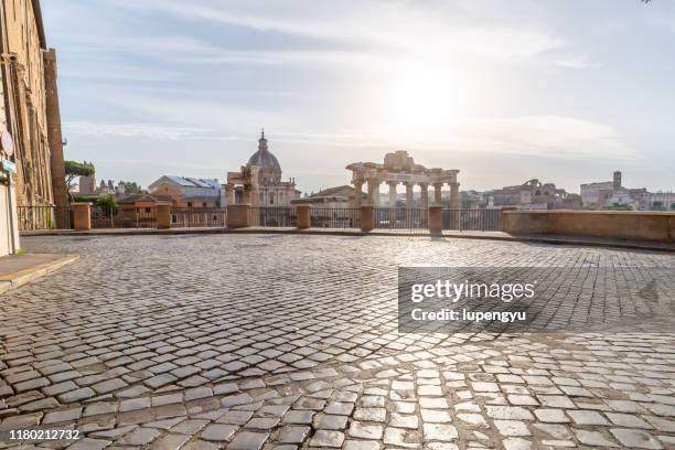 the roman forum at sunrise, rome, italy - pflasterstein stock-fotos und bilder