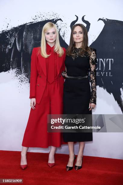 Elle Fanning and Angelina Jolie attend a photocall for "Maleficent: Mistress of Evil" at Mandarin Oriental Hotel on October 10, 2019 in London,...