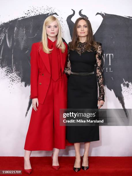 Elle Fanning and Angelina Jolie attend a photocall for "Maleficent: Mistress of Evil" at Mandarin Oriental Hotel on October 10, 2019 in London,...