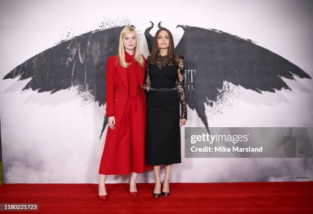 Elle Fanning and Angelina Jolie attend a photocall for "Maleficent: Mistress of Evil" at Mandarin Oriental Hotel on October 10, 2019 in London,...