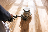 a professional master cleans the floor with a polishing machine