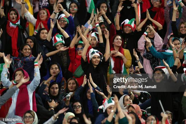 Female football fans show their support during of the FIFA World Cup Qualifier match between Iran and Cambodia at Azadi Stadium on October 10, 2019...