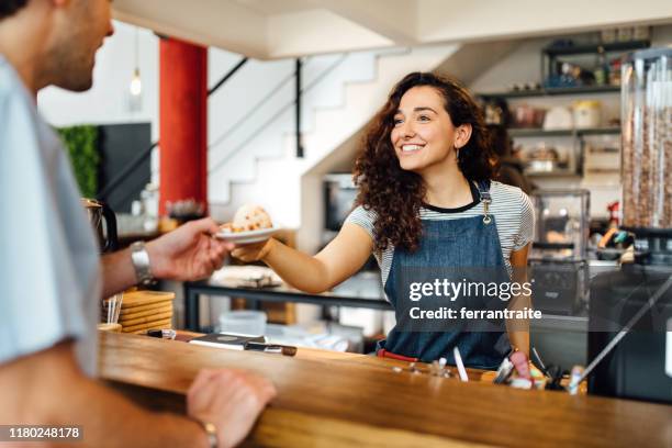barista serving client over counter - buenos aires food stock pictures, royalty-free photos & images
