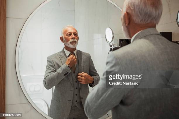businessman dressing up in bathroom taking care of tie - tied up stock pictures, royalty-free photos & images