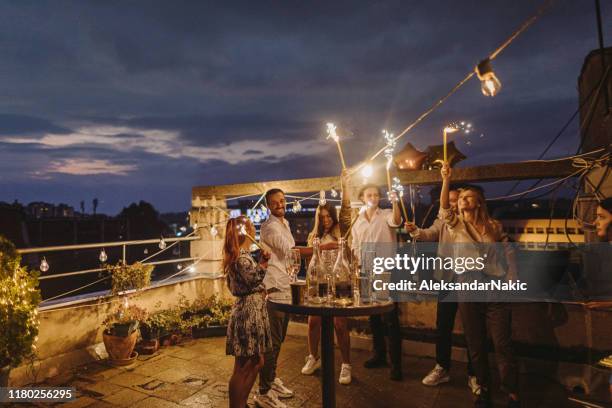 rooftop party at night - champagne rooftop stock pictures, royalty-free photos & images