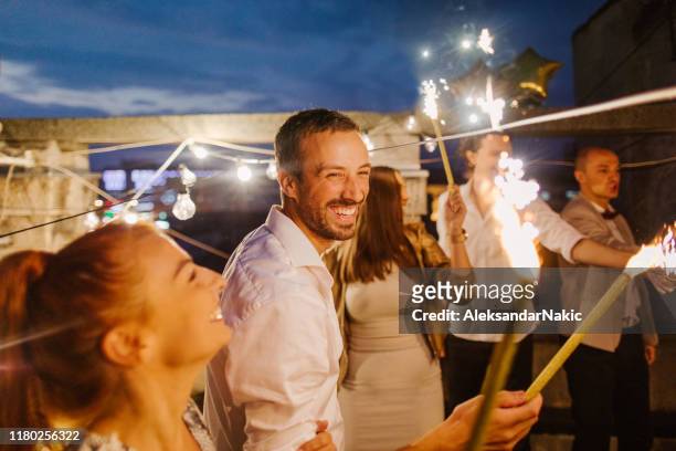 rooftop party at night - fireworks dusk stock pictures, royalty-free photos & images
