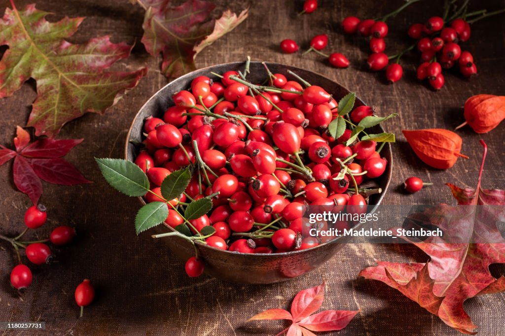 Fresh rose hips in a bowl on a table