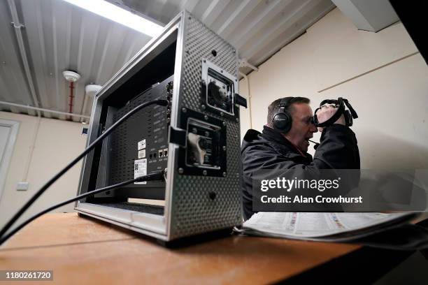 Racecourse commentator John Hunt calls them home at Kempton Park Racecourse on October 10, 2019 in Sunbury, England.