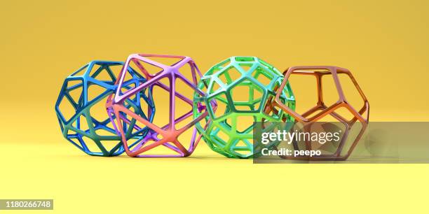 four different, multi-coloured, geometric shapes connected together  on yellow background - abstract diversity stock pictures, royalty-free photos & images