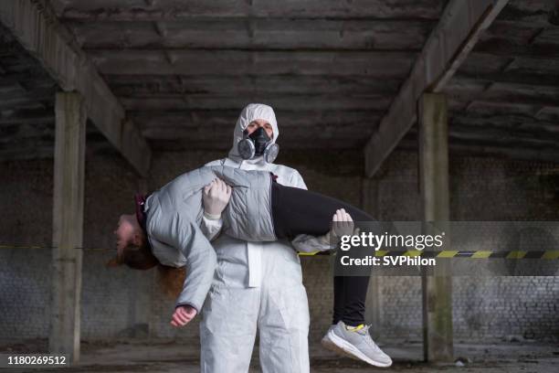 the rescuer carries the injured person in his arms. - chernobyl children stock pictures, royalty-free photos & images