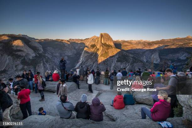 Hundreds of visitors gather at Glacier Point to watch the sunset over Half Dome and the sweeping Sierra Nevada Mountain Range on October 5 in...